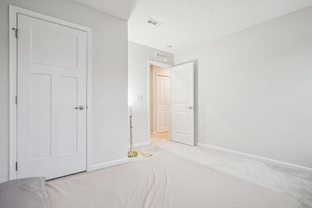 unfurnished bedroom featuring light colored carpet