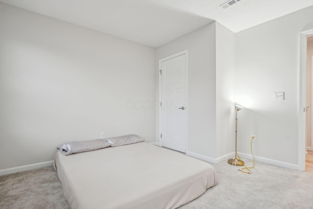 bedroom featuring light carpet