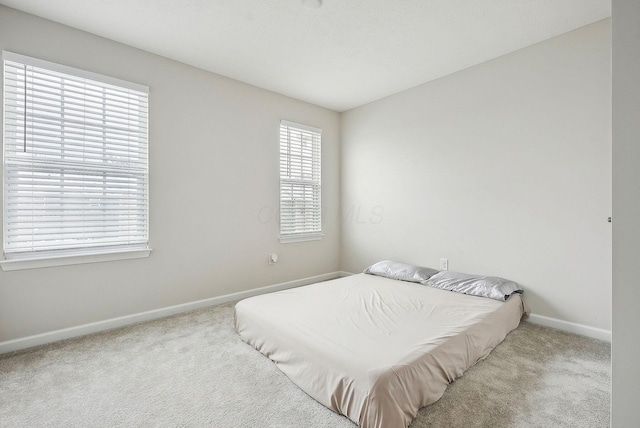 bedroom featuring light colored carpet