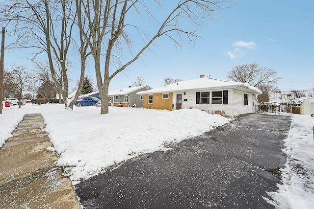 view of snow covered back of property