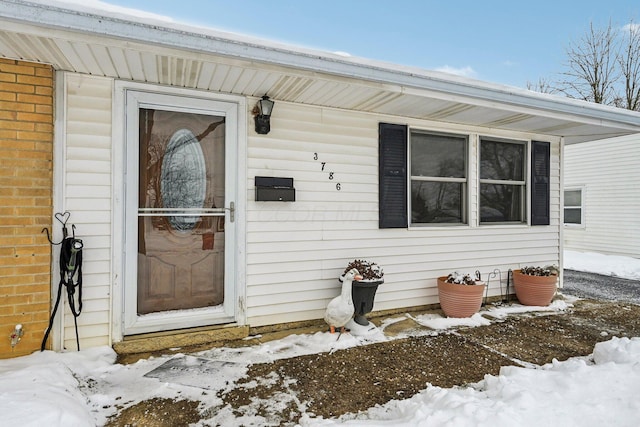 view of snow covered property entrance