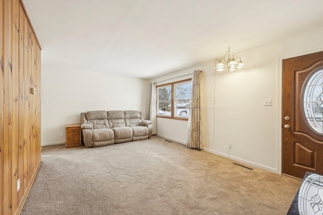 living room featuring a notable chandelier and light carpet