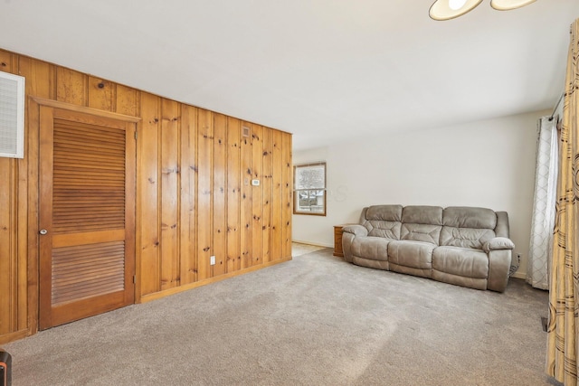 living room featuring light colored carpet and wooden walls