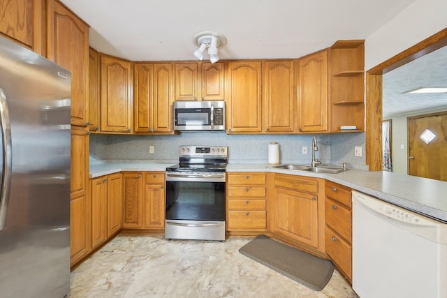 kitchen featuring decorative backsplash, stainless steel appliances, and sink