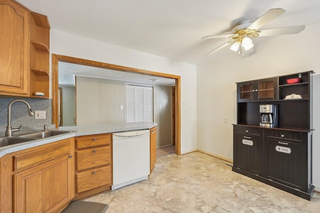 kitchen featuring tasteful backsplash, ceiling fan, dishwasher, and sink