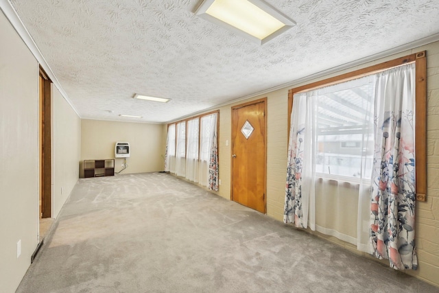 foyer entrance featuring carpet flooring, heating unit, and a textured ceiling