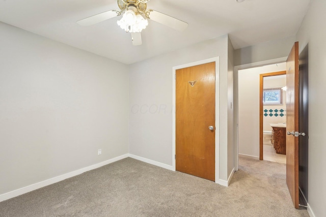 unfurnished bedroom with ceiling fan and light carpet