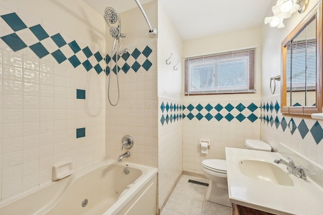 full bathroom featuring tile patterned floors, toilet, vanity, tile walls, and tiled shower / bath