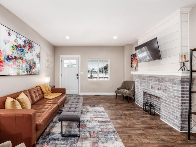 living room with a fireplace and dark hardwood / wood-style floors