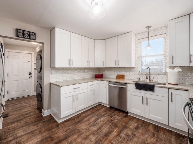 kitchen featuring dark hardwood / wood-style flooring, stacked washer and clothes dryer, stainless steel dishwasher, and white cabinets