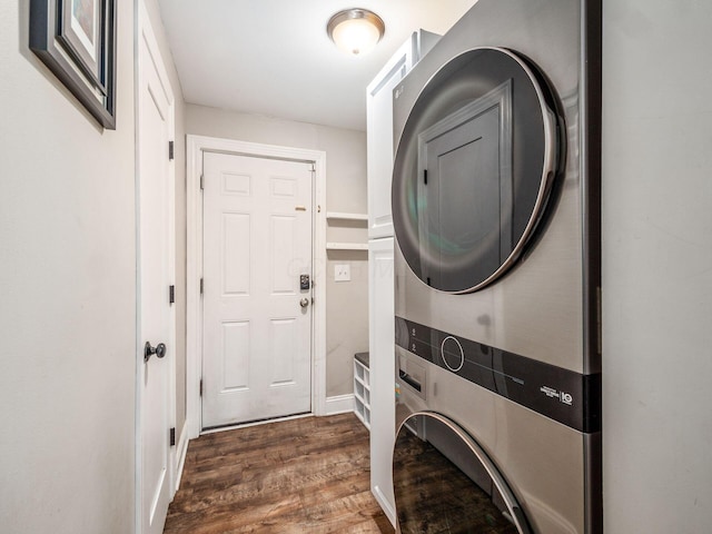 clothes washing area with dark hardwood / wood-style flooring and stacked washing maching and dryer