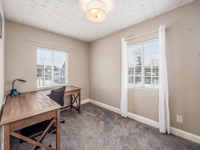 home office with carpet and a textured ceiling