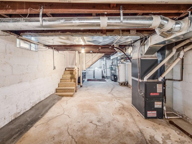 basement with water heater, washer and dryer, and heating unit