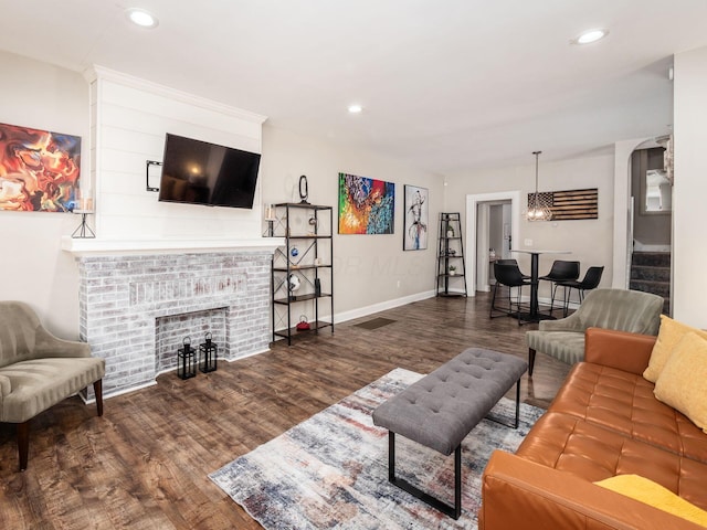 living room with a fireplace and dark hardwood / wood-style floors