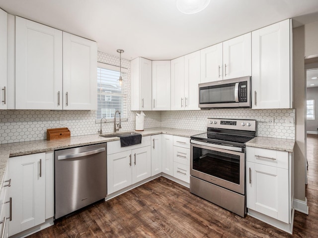 kitchen with white cabinets, appliances with stainless steel finishes, and sink