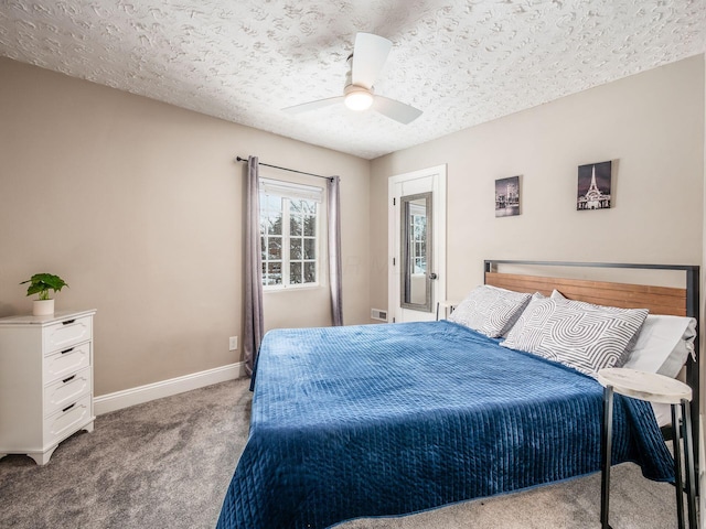 bedroom featuring ceiling fan, light colored carpet, and a textured ceiling