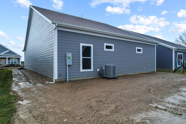 rear view of property with cooling unit