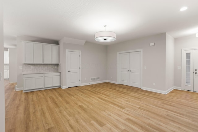 unfurnished living room with light hardwood / wood-style flooring