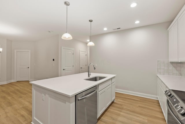 kitchen with tasteful backsplash, sink, white cabinets, and stainless steel appliances