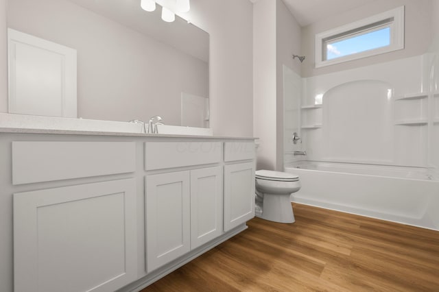 full bathroom featuring hardwood / wood-style flooring, vanity, shower / bathtub combination, and toilet