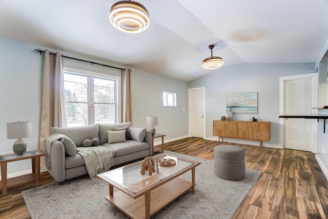 living room with hardwood / wood-style flooring and vaulted ceiling