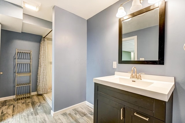 bathroom featuring hardwood / wood-style floors, vanity, and a shower with curtain