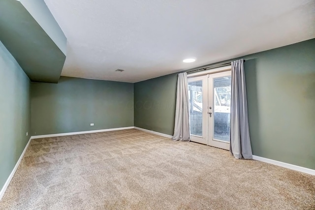 carpeted spare room with french doors