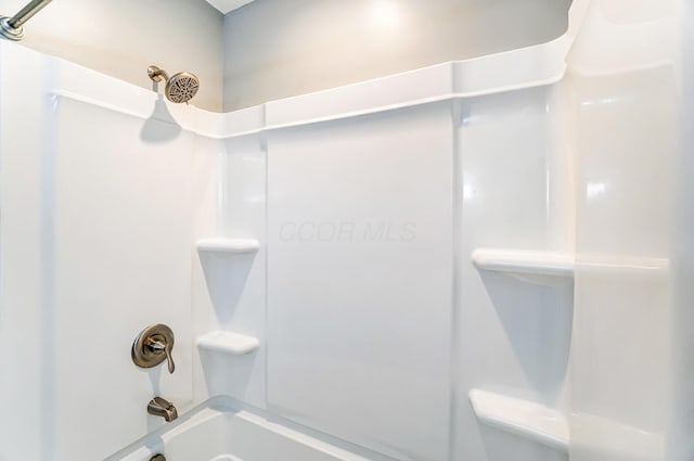 bathroom with bathing tub / shower combination