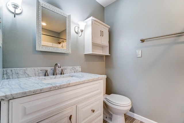 bathroom featuring hardwood / wood-style floors, vanity, and toilet