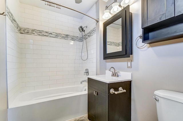 full bathroom with vanity, tiled shower / bath combo, and toilet