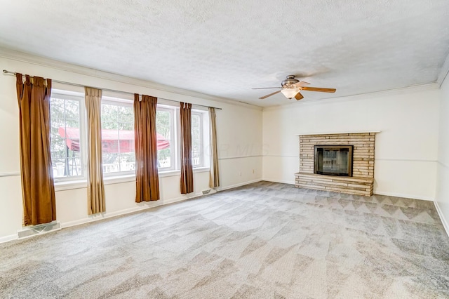 unfurnished living room with a textured ceiling, ceiling fan, crown molding, and light carpet