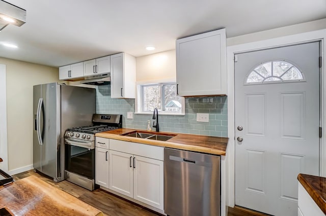 kitchen featuring white cabinets, sink, appliances with stainless steel finishes, and wooden counters