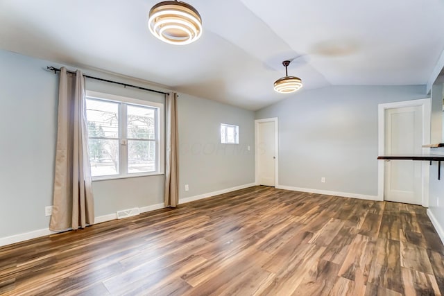 interior space featuring dark hardwood / wood-style floors and vaulted ceiling