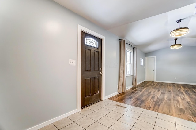 tiled entrance foyer featuring lofted ceiling