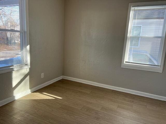 spare room with hardwood / wood-style flooring