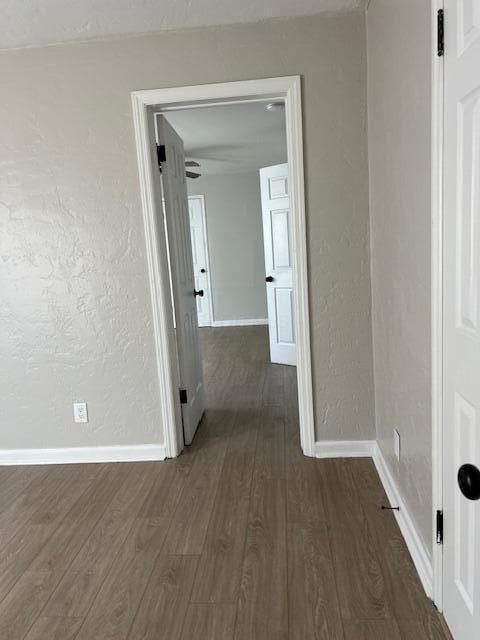 hallway with dark hardwood / wood-style floors