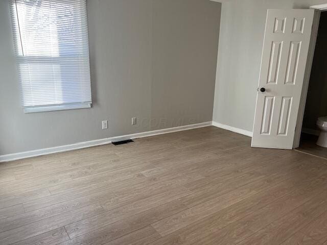 unfurnished room with a healthy amount of sunlight and light wood-type flooring