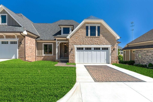 1474 Dogwood Loop, Powell, OH 43065 - craftsman-style house featuring stone siding, a front yard, board and batten siding, and decorative driveway