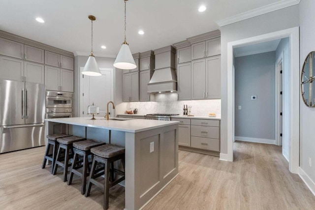1474 Dogwood Loop, Powell, OH 43065 - kitchen featuring custom range hood, backsplash, gray cabinets, and appliances with stainless steel finishes