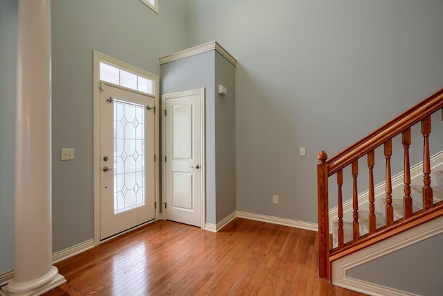 entryway with wood-type flooring and ornate columns