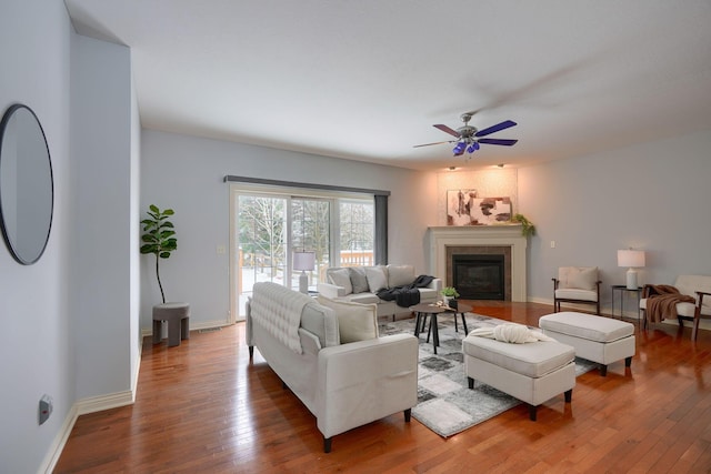 living room featuring hardwood / wood-style flooring and ceiling fan