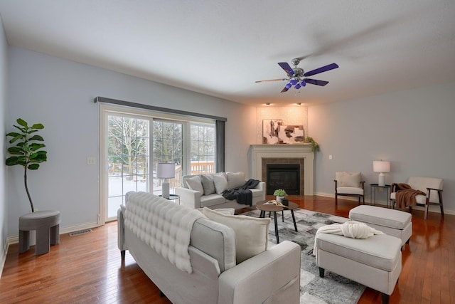 living room featuring ceiling fan and hardwood / wood-style floors