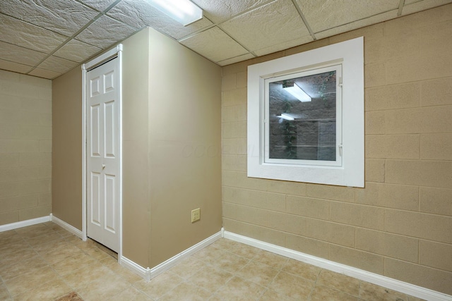 interior space with a paneled ceiling