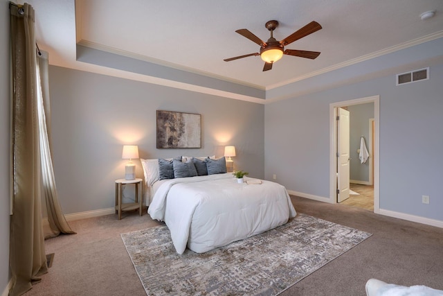 bedroom featuring ceiling fan, a raised ceiling, light colored carpet, and crown molding