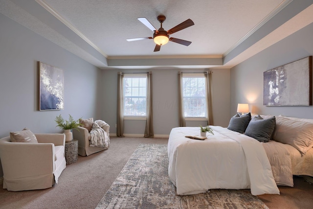 bedroom featuring carpet flooring, ceiling fan, a raised ceiling, crown molding, and a textured ceiling