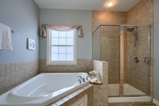 bathroom with shower with separate bathtub