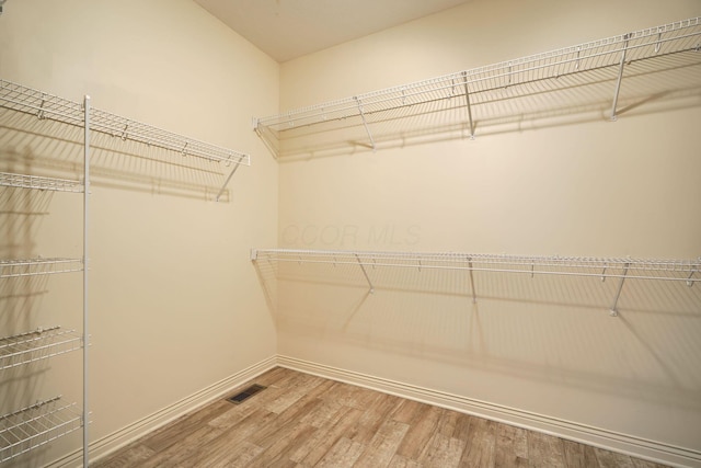 spacious closet featuring hardwood / wood-style floors