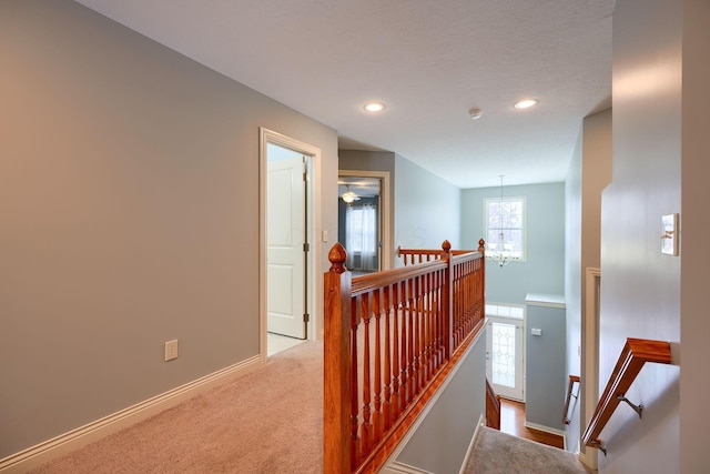 corridor with light colored carpet and plenty of natural light