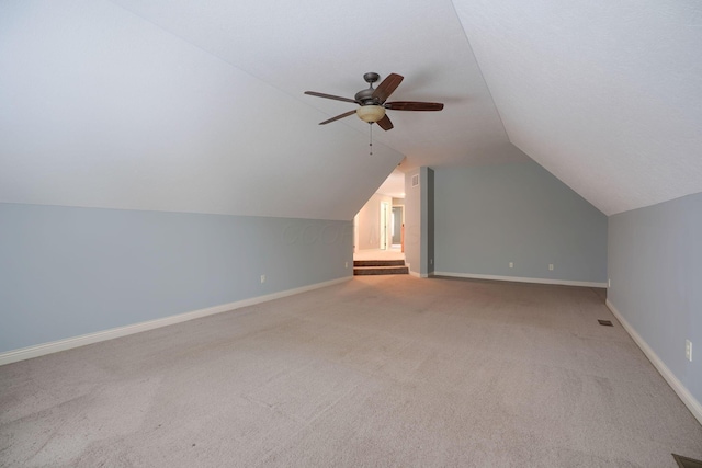 bonus room with carpet flooring, vaulted ceiling, and ceiling fan