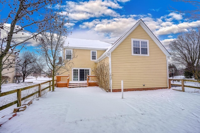 snow covered property with central air condition unit